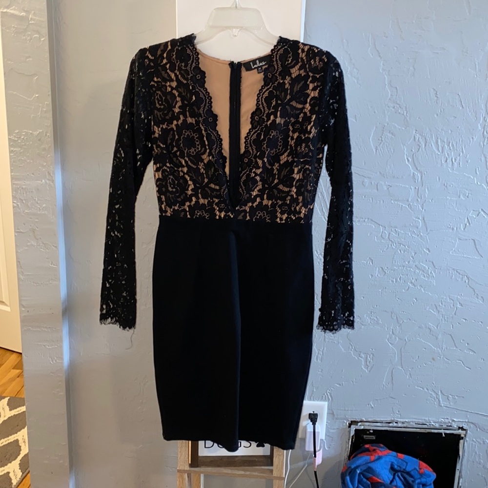 Black lace tight fitting long sleeve dress. Deep V neck